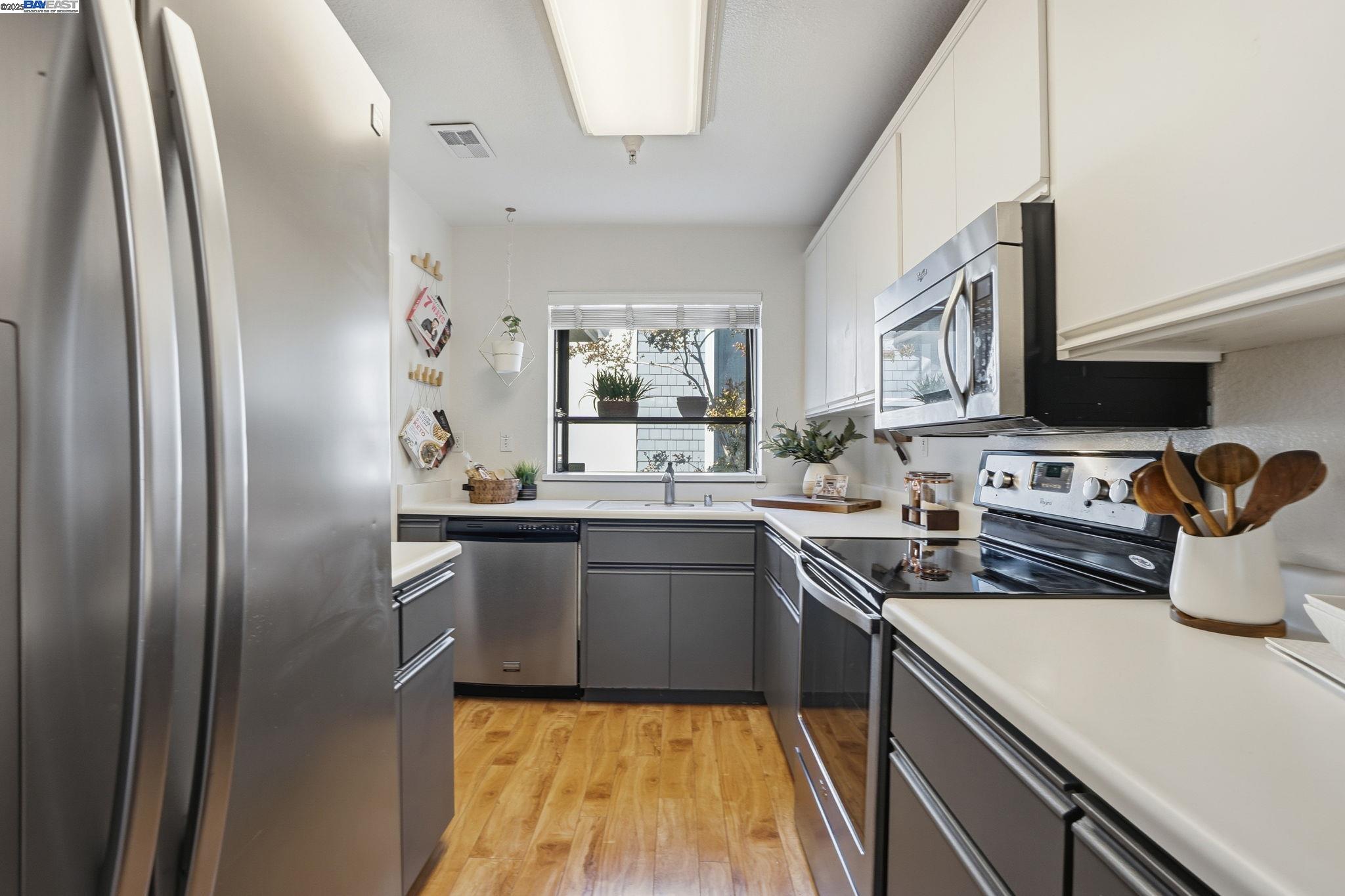 2586 Oak Road, Unit 229 Walnut Creek, CA 94597 - Photo 12 of 39 a kitchen with stainless steel appliances granite countertop a refrigerator sink and stove