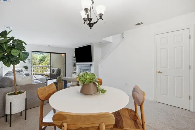 a dining room with furniture a livingroom and chandelier