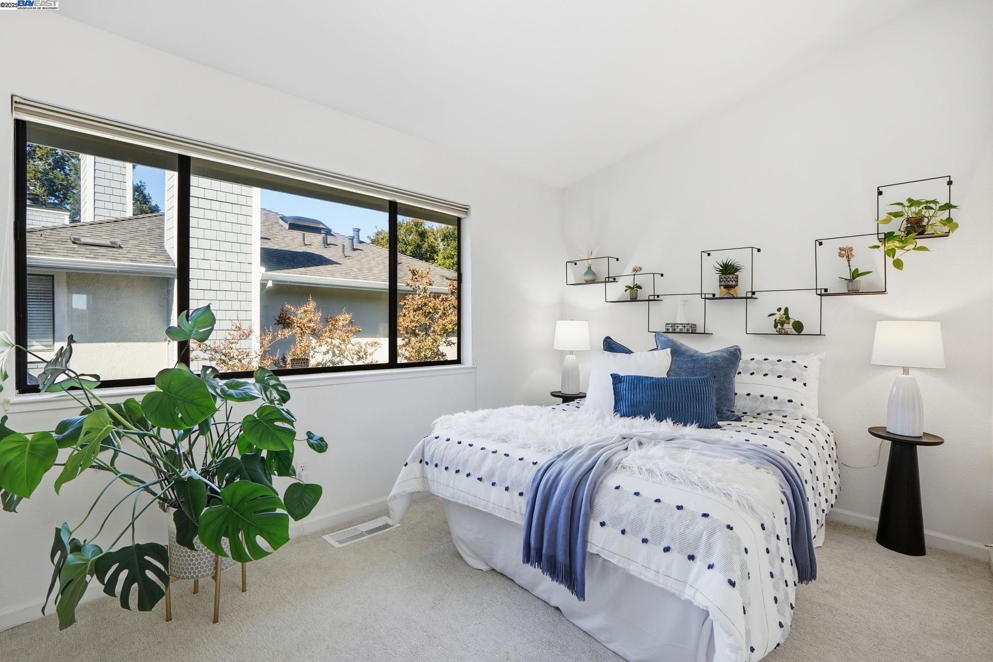 2586 Oak Road, Unit 229 Walnut Creek, CA 94597 - Photo 17 of 39 a bedroom with bed and a potted plant