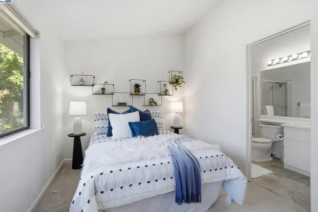 a bed room with a bed and a plant