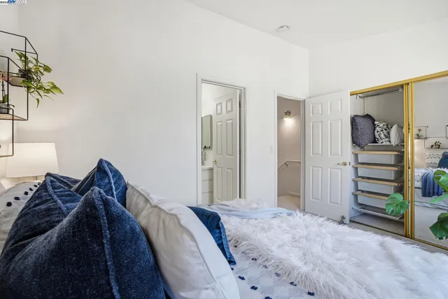 a bed sitting in a bedroom next to a window