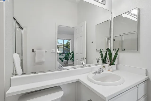 a bathroom with a double vanity sink and a mirror