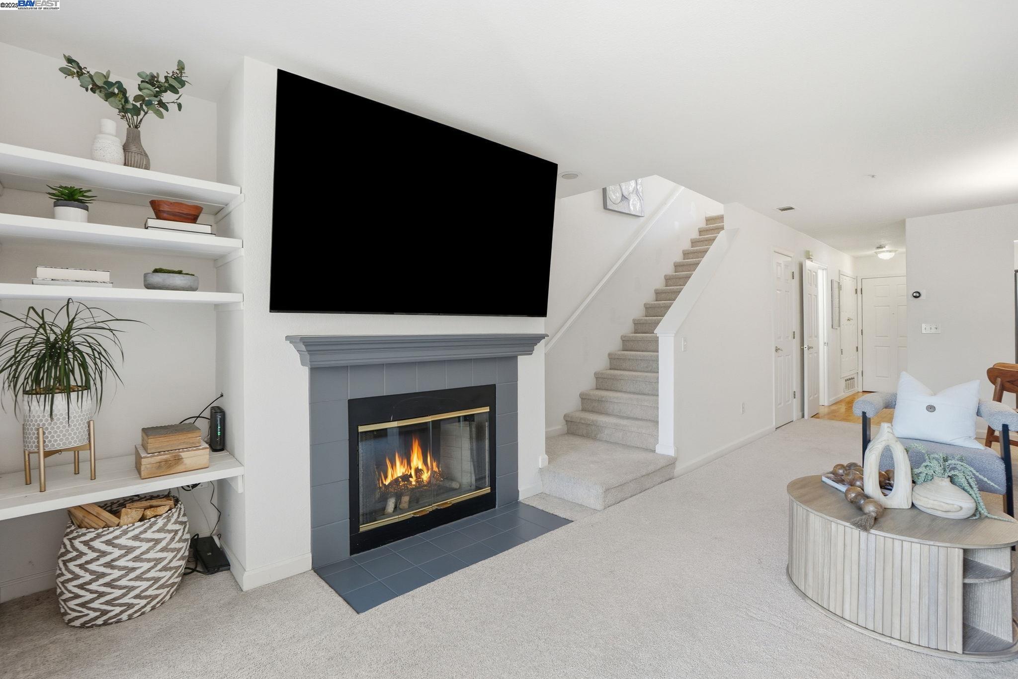 2586 Oak Road, Unit 229 Walnut Creek, CA 94597 - Photo 8 of 39 a living room with furniture a fireplace and a flat screen tv