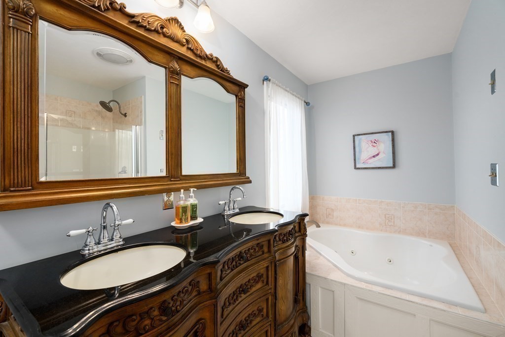 238 West Acton Road Stow, MA 01775 - Photo 16 of 37 a bathroom with a granite countertop sink mirror and a bathtub