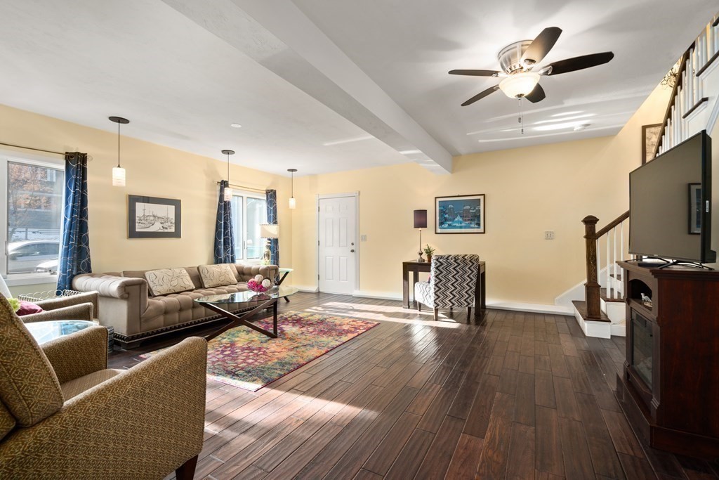 238 West Acton Road Stow, MA 01775 - Photo 24 of 37 a living room with furniture a ceiling fan and a flat screen tv