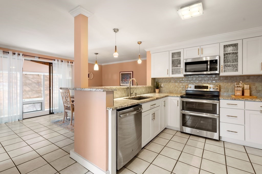 238 West Acton Road Stow, MA 01775 - Photo 9 of 37 a kitchen with a stove a sink and a microwave