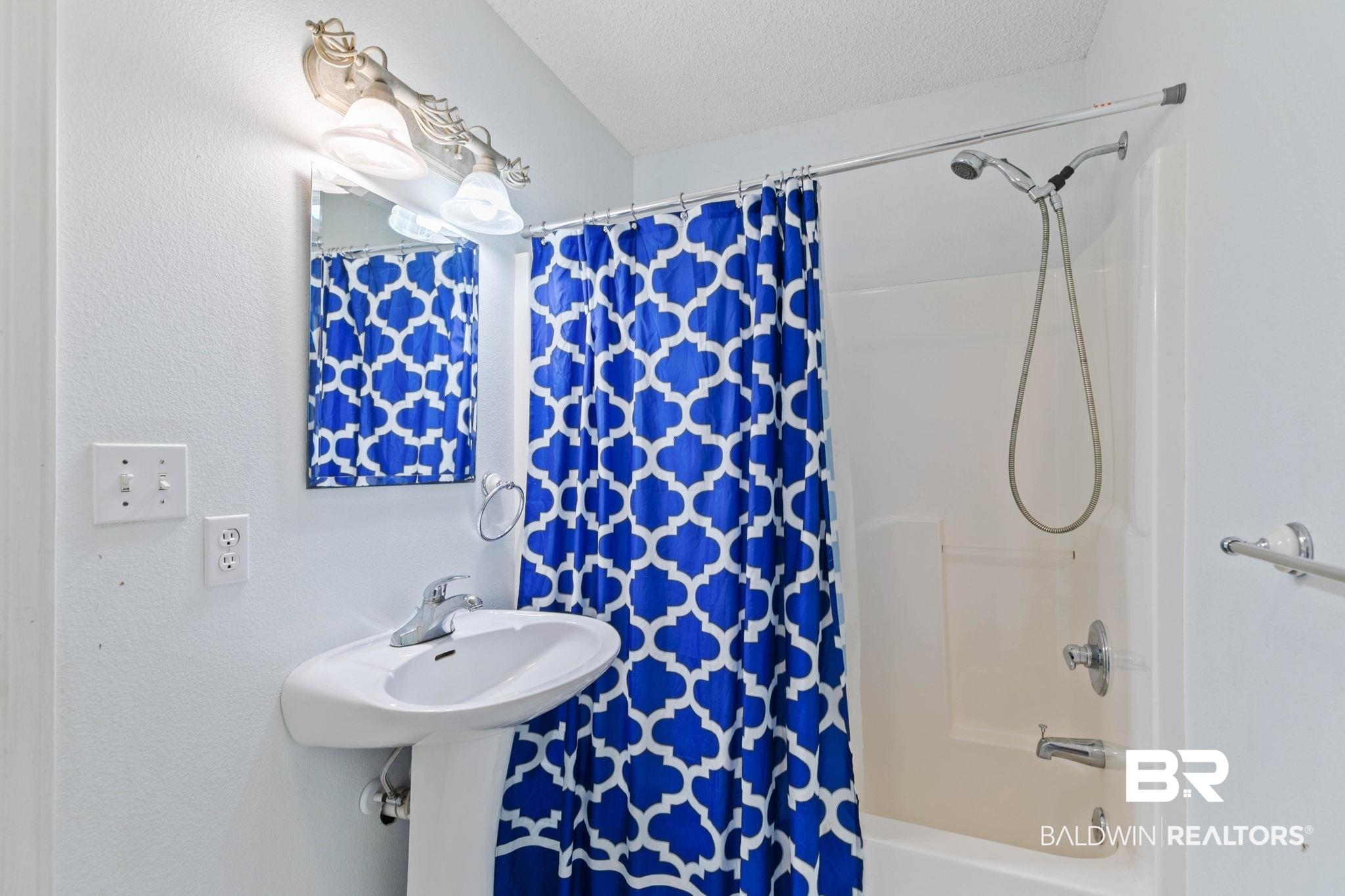 20219 Greek Cemetery Road Robertsdale, AL 36567 - Photo 31 of 41 Bathroom featuring a pedestal sink, chrome faucet, and a shower/tub combination with a handheld showerhead