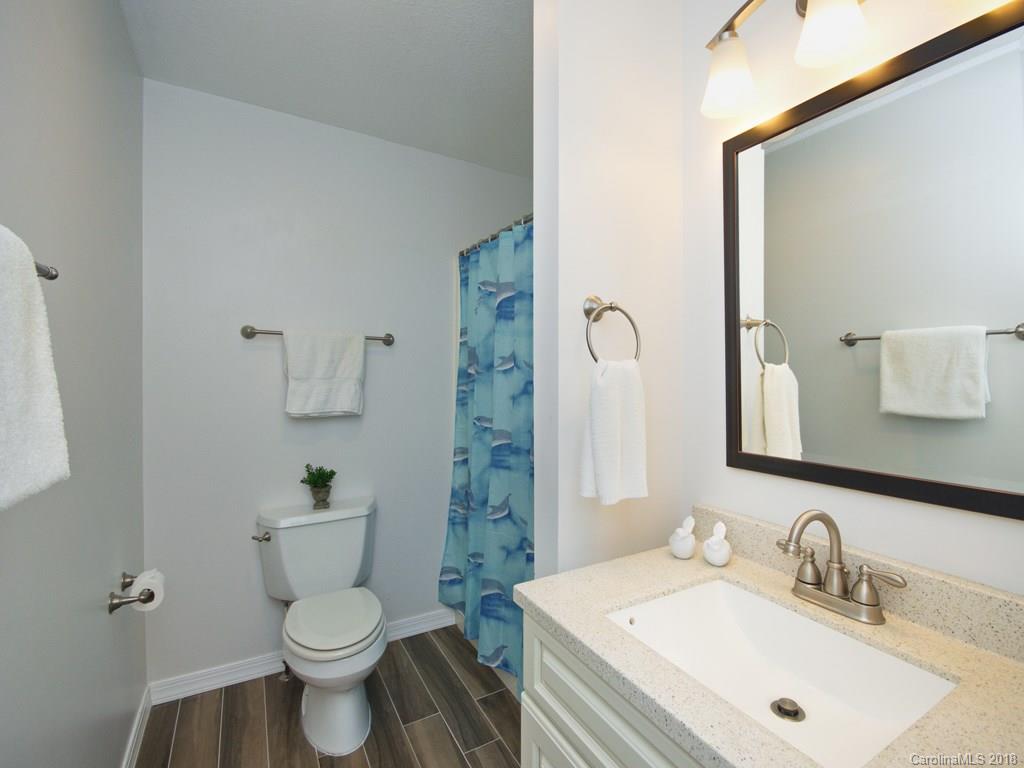 39 Forest Road Canton, NC 28716 - Photo 16 of 18 a bathroom with a sink toilet vanity and shower
