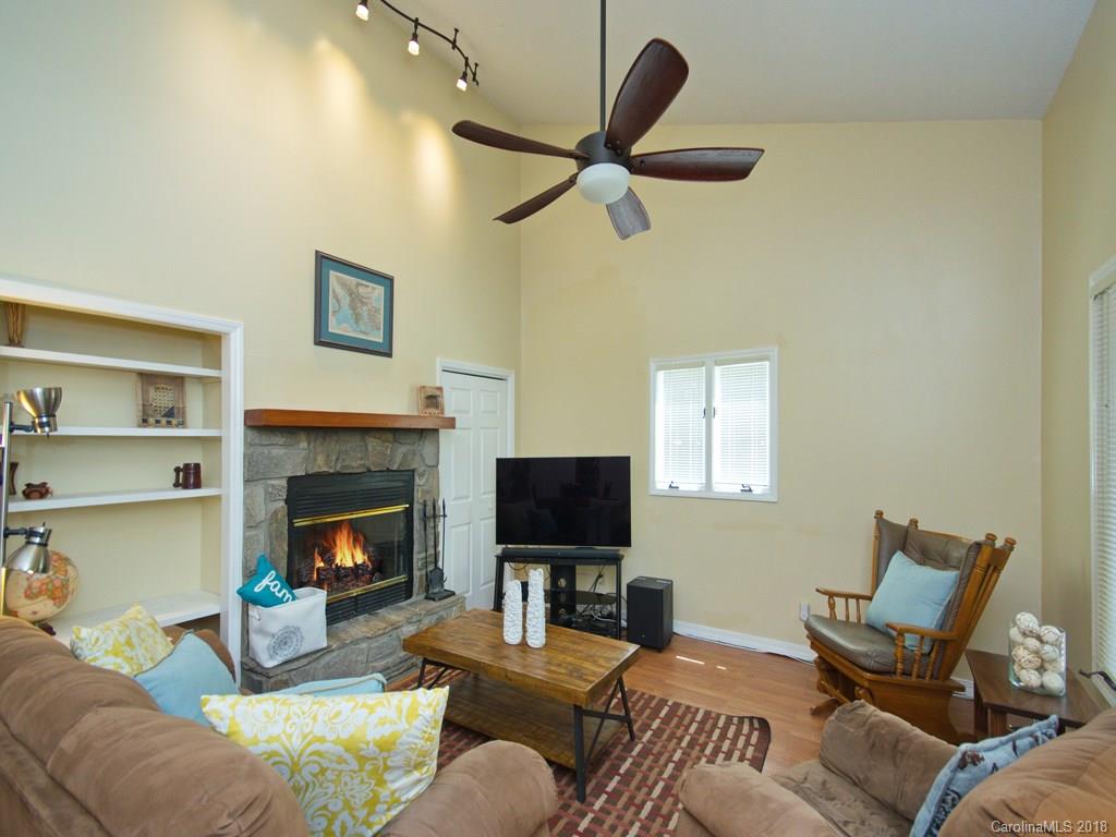 39 Forest Road Canton, NC 28716 - Photo 3 of 18 a living room with furniture a flat screen tv and a fireplace