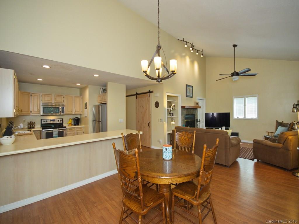 39 Forest Road Canton, NC 28716 - Photo 8 of 18 a view of a dining room and livingroom with furniture wooden floor a chandelier