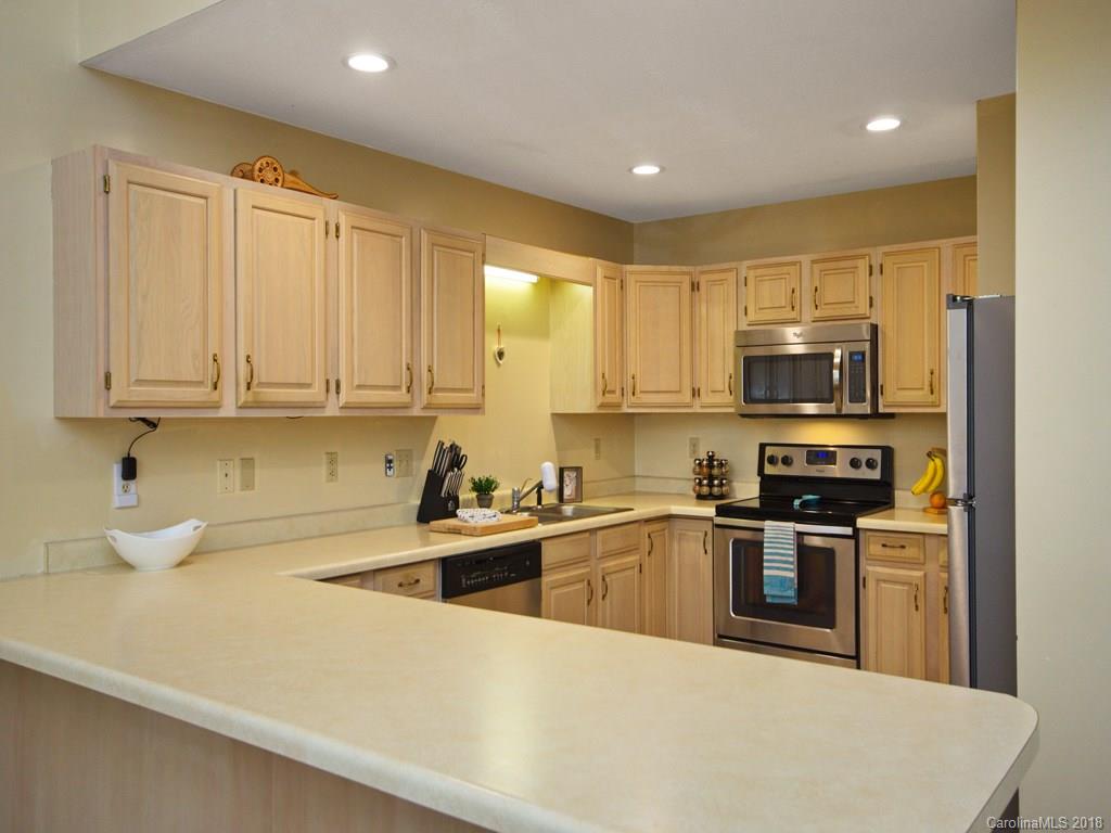 39 Forest Road Canton, NC 28716 - Photo 10 of 18 a kitchen with stainless steel appliances granite countertop a sink a stove and cabinets