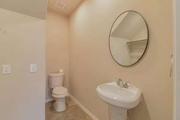 a bathroom with a sink a mirror and a toilet