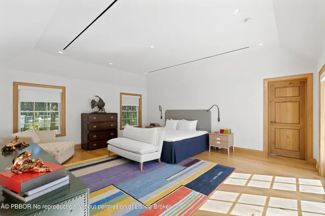 a living room with furniture a rug and a window