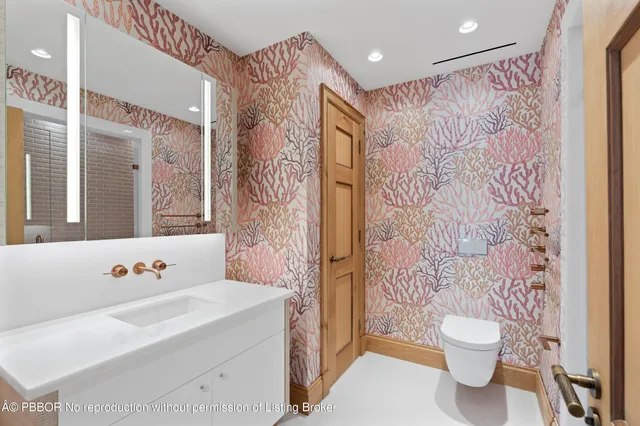 a bathroom with a sink a toilet and a shower curtain