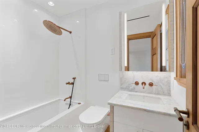 a bathroom with a sink a toilet and a bathtub