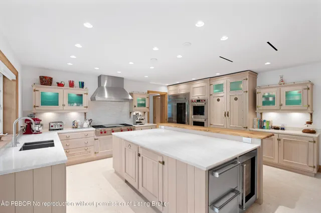 a kitchen with stainless steel appliances a sink stove and cabinets