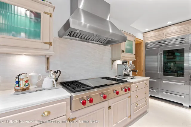 a kitchen that has a stove and a wooden floor