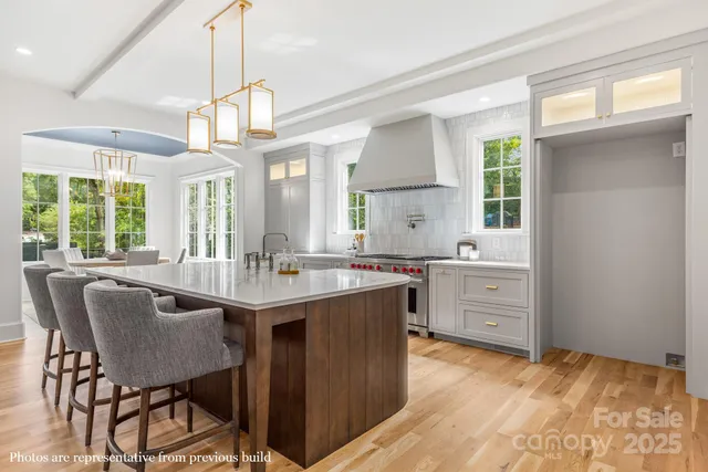 a kitchen with stainless steel appliances granite countertop a sink a stove and a refrigerator