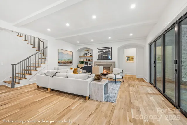 a living room with furniture window and a wooden floor