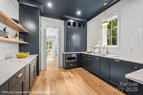 a kitchen with stainless steel appliances granite countertop a sink and wooden cabinets