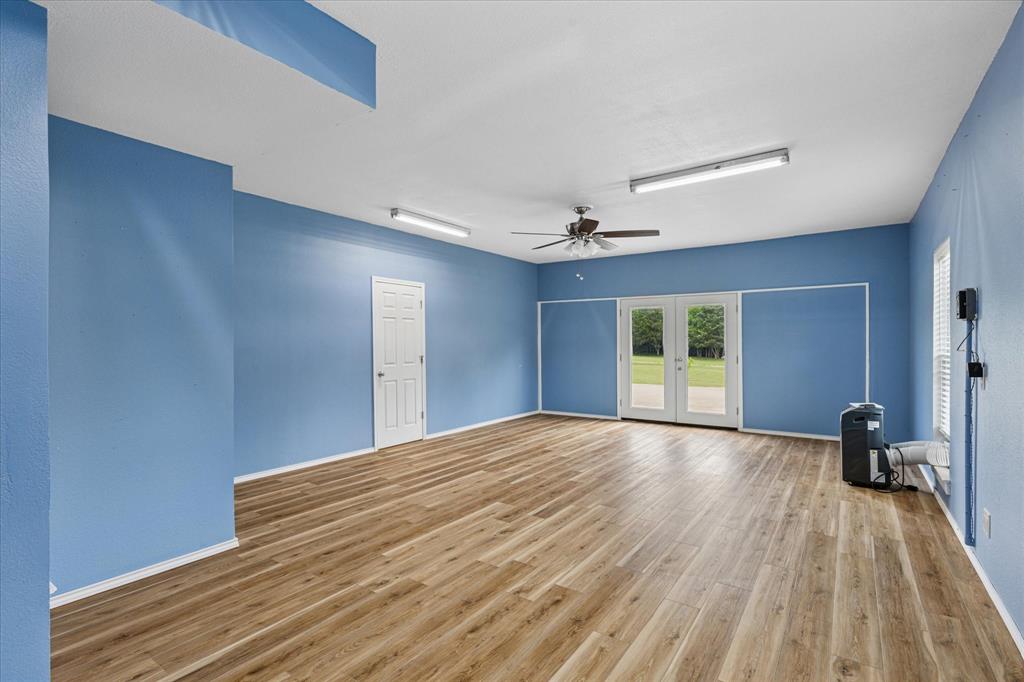 6251 Hayes Road Midlothian, TX 76065 - Photo 19 of 30 a view of empty room with wooden floor and fan
