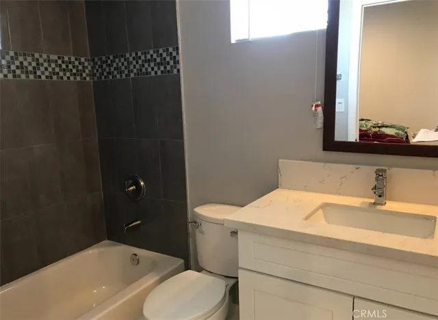 a bathroom with a sink toilet and vanity