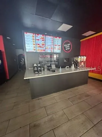 a room with a sink a mirror and window