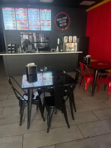 a view of a dining room with furniture and window