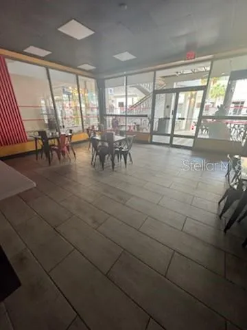 a view of a dining area with furniture and floor to ceiling window