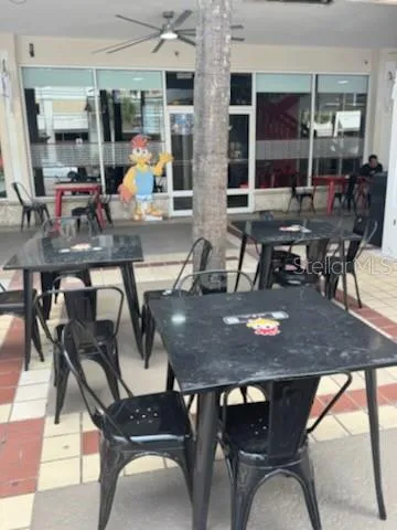 a outdoor dining space with furniture and chandelier