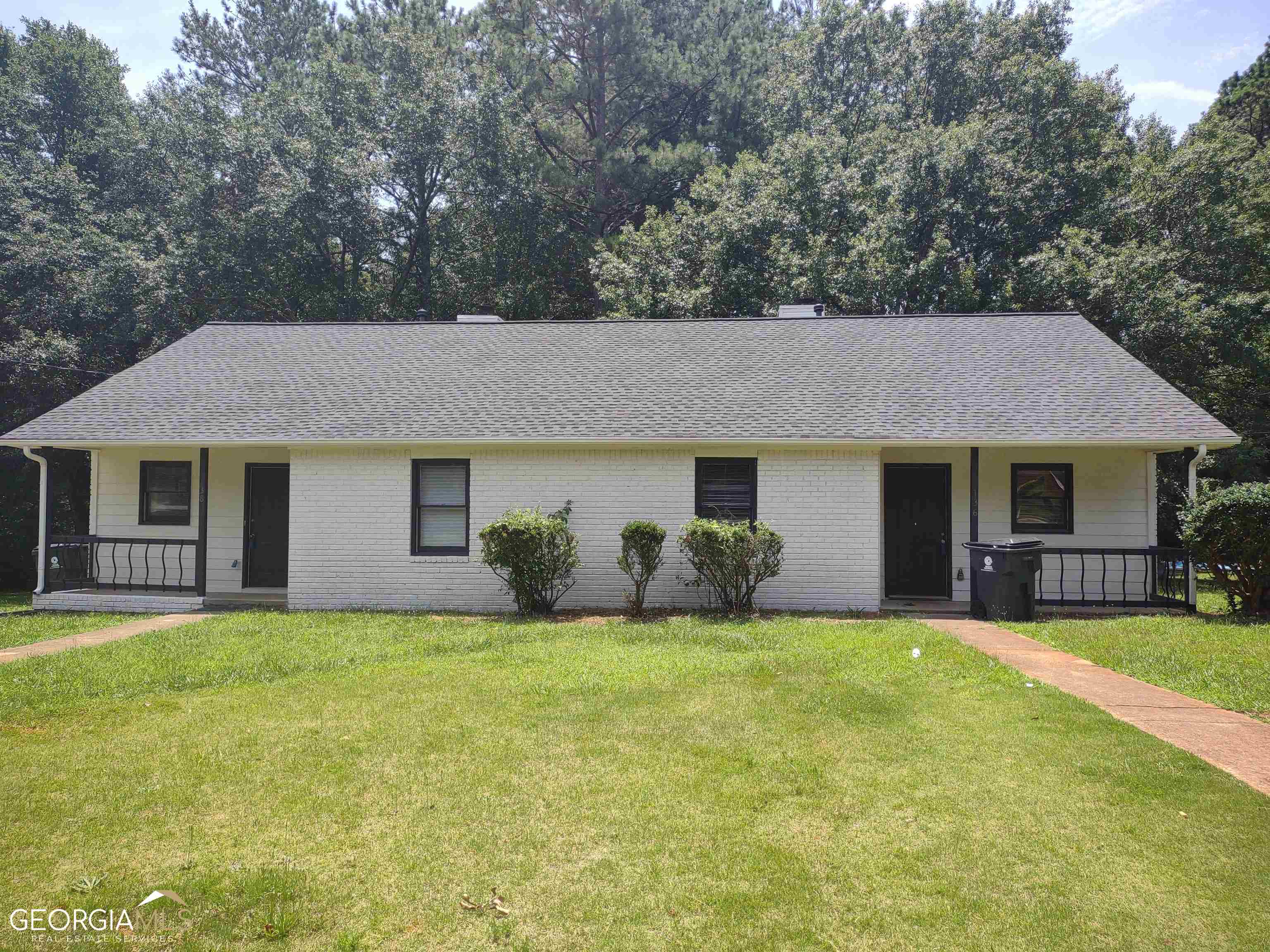 136 Appleton Boulevard, Unit 1 Stockbridge, GA 30281 - Photo 1 of 1 a front view of a house with a yard and trees