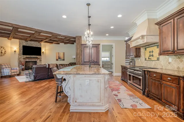 a large kitchen with kitchen island granite countertop a large counter top and stainless steel appliances