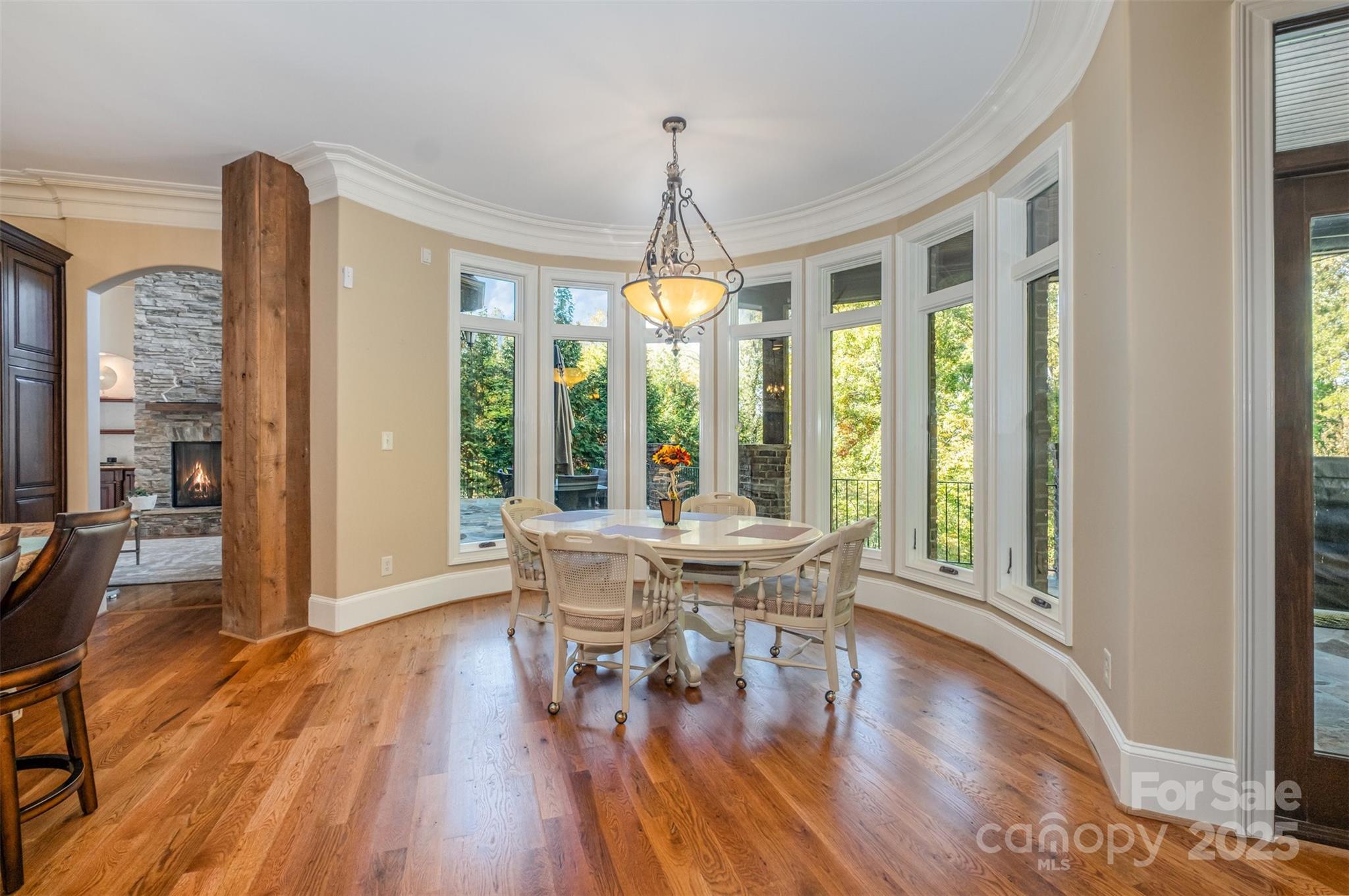 1610 Lookout Circle Waxhaw, NC 28173 - Photo 19 of 44 a dining room with wooden floor a chandelier a glass table and chairs