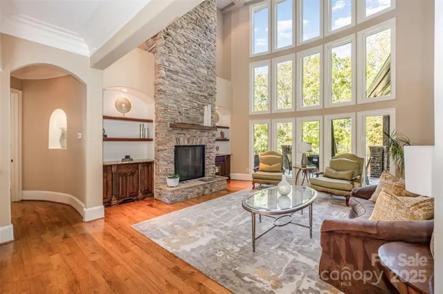 a living room with furniture a rug and a chandelier