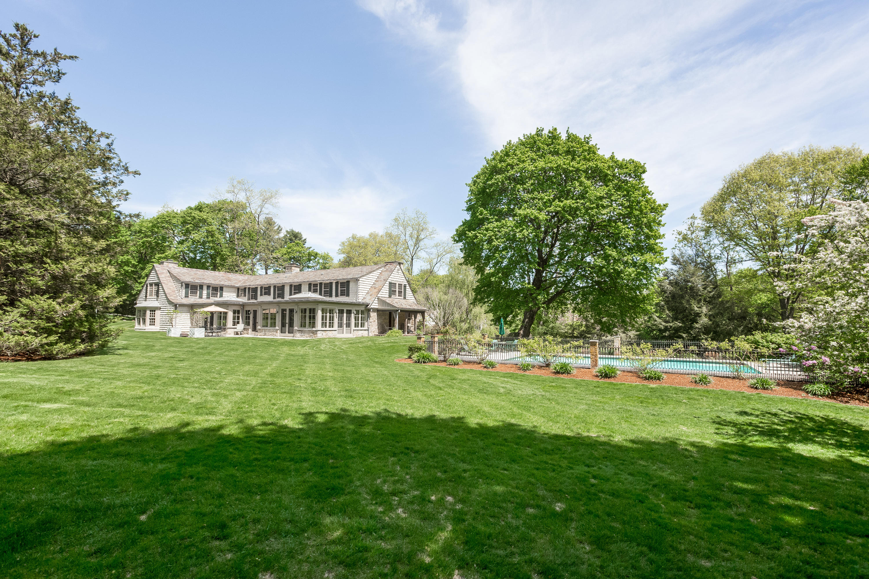18 Wee Burn Lane Darien, CT 06820 - Photo 49 of 56 a front view of a house with a garden