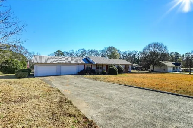 a front view of house with yard and lake view