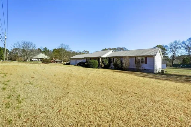 a swimming pool with an outdoor space and seating area