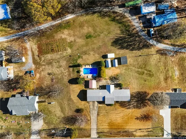 an aerial view of residential houses with outdoor space