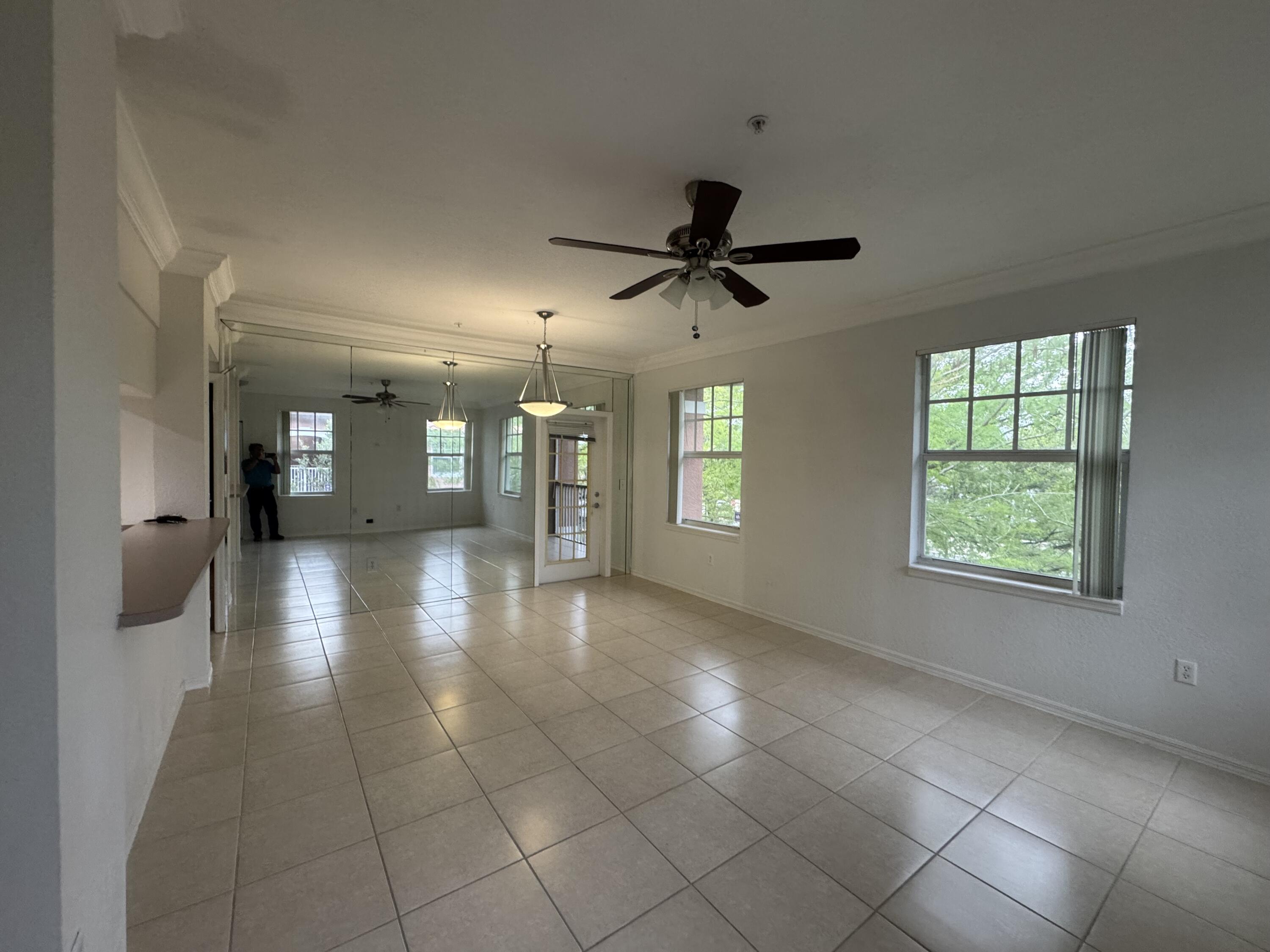6650 West Sample Road Coral Springs, FL 33067 - Photo 3 of 15 a view of a livingroom with a ceiling fan and window