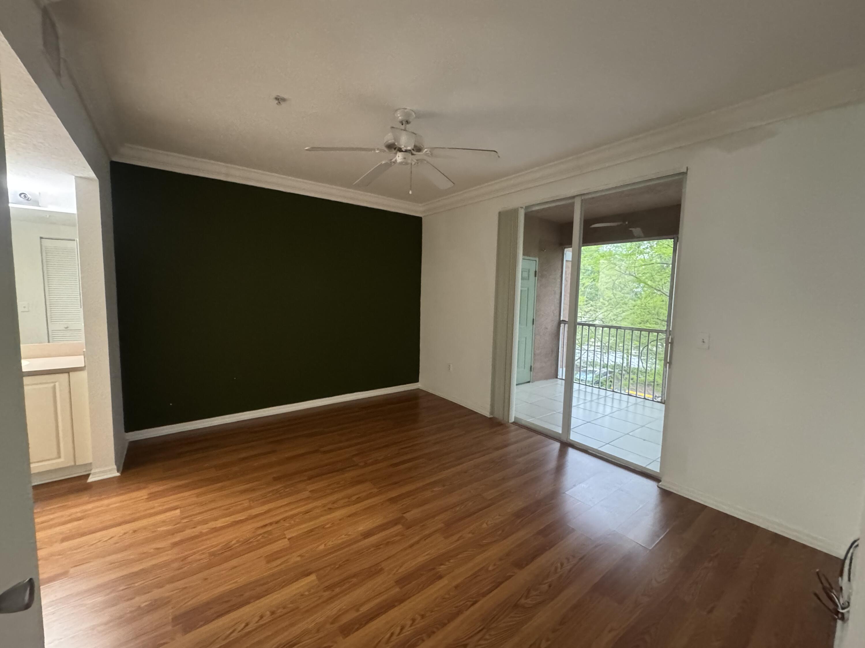 6650 West Sample Road Coral Springs, FL 33067 - Photo 6 of 15 wooden floor in an empty room with a window