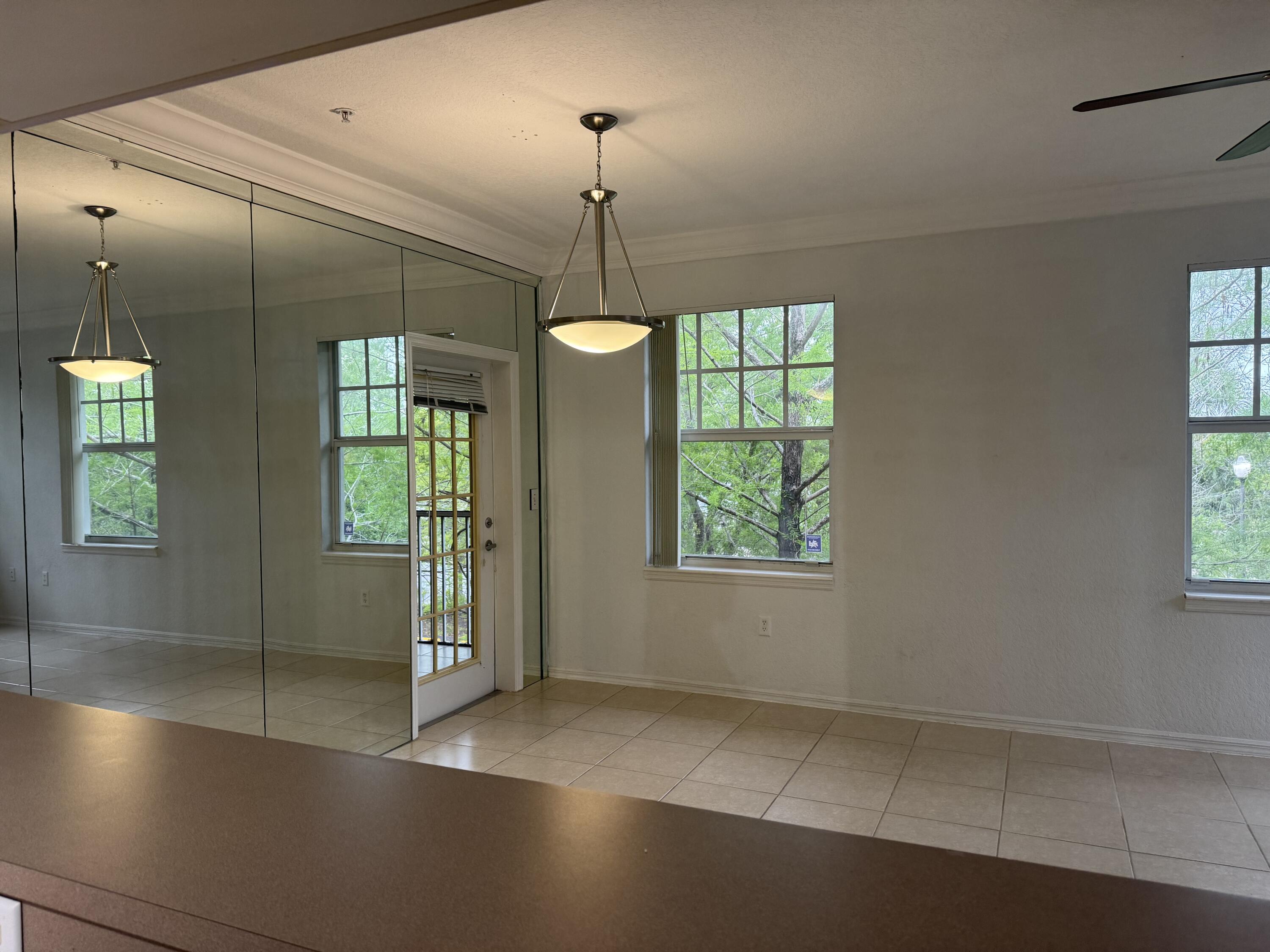 6650 West Sample Road Coral Springs, FL 33067 - Photo 9 of 15 an empty room with windows and outdoor view