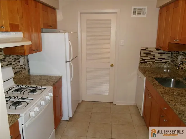 a kitchen with a stove and a refrigerator
