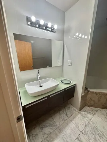 a bathroom with a sink a toilet a mirror and vanity
