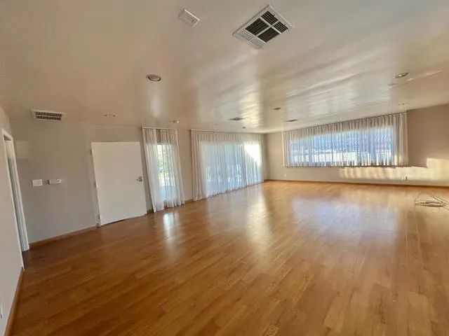 a view of a balcony with wooden floor