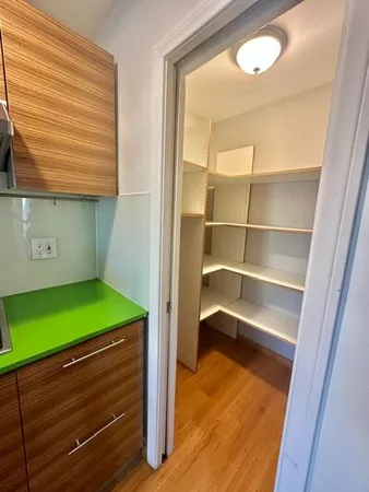 a room with window and refrigerator