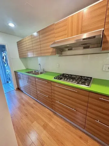 a kitchen with wooden floors and a sink