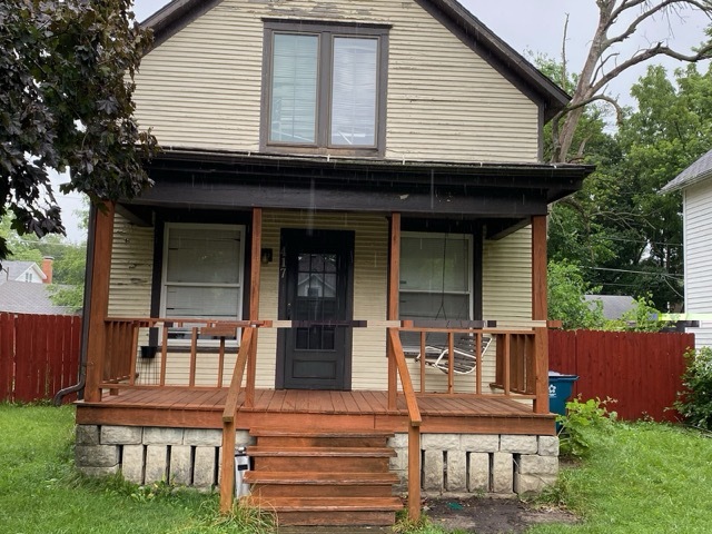 a front view of a house with sitting area