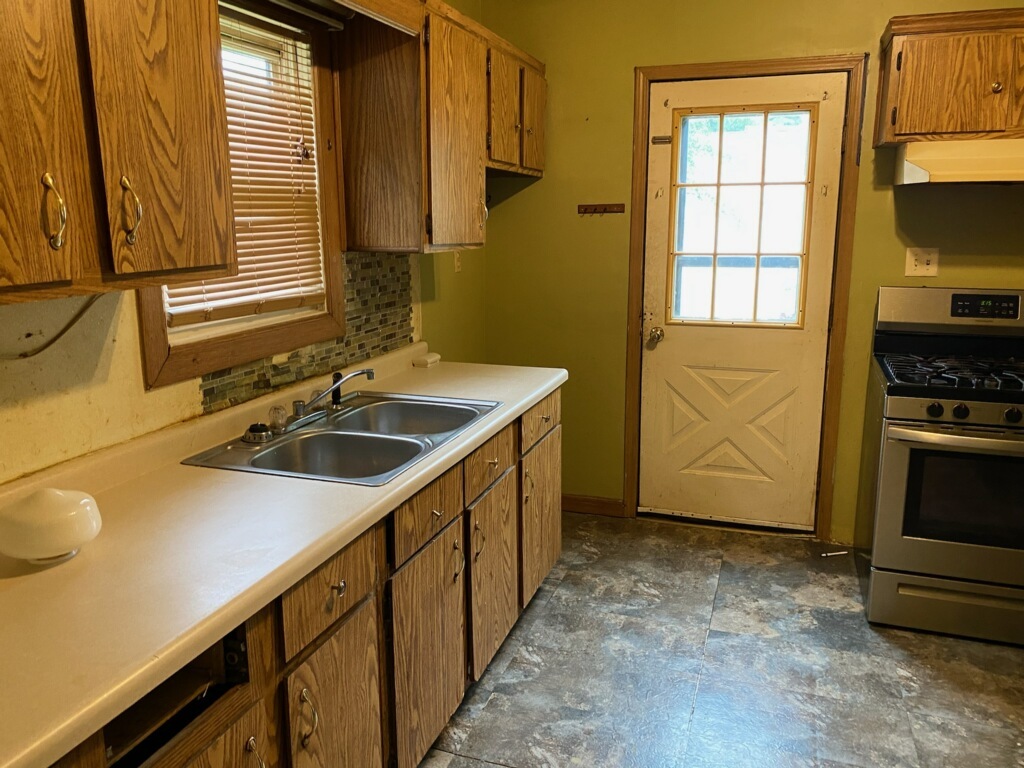 417 East Timber Street Pontiac, IL 61764 - Photo 4 of 10 a kitchen with a sink stove and cabinets