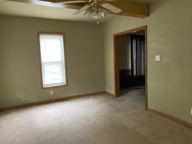 417 East Timber Street Pontiac, IL 61764 - Photo 9 of 10 an empty room with a ceiling fan and window
