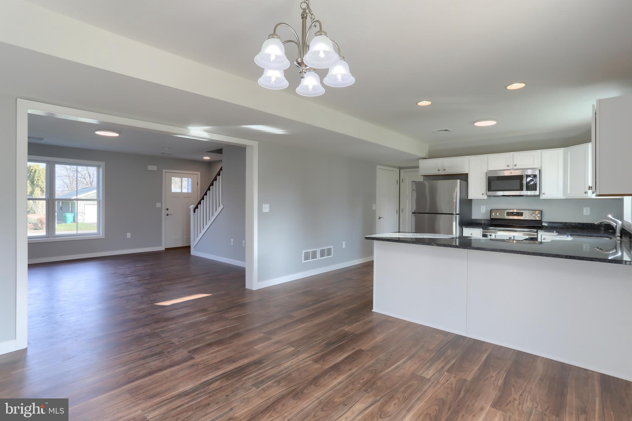176 Lamp Post Lane Hershey, PA 17033 - Photo 12 of 33 a view of a kitchen with stove and wooden floor